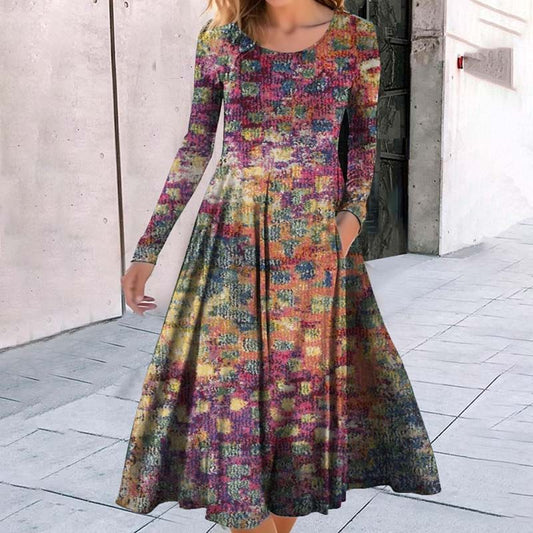 The dress features a blend of colors, including shades of purple, orange, yellow, and green. The overall pattern appears to be a mix of these hues creating a vibrant, artistic effect.